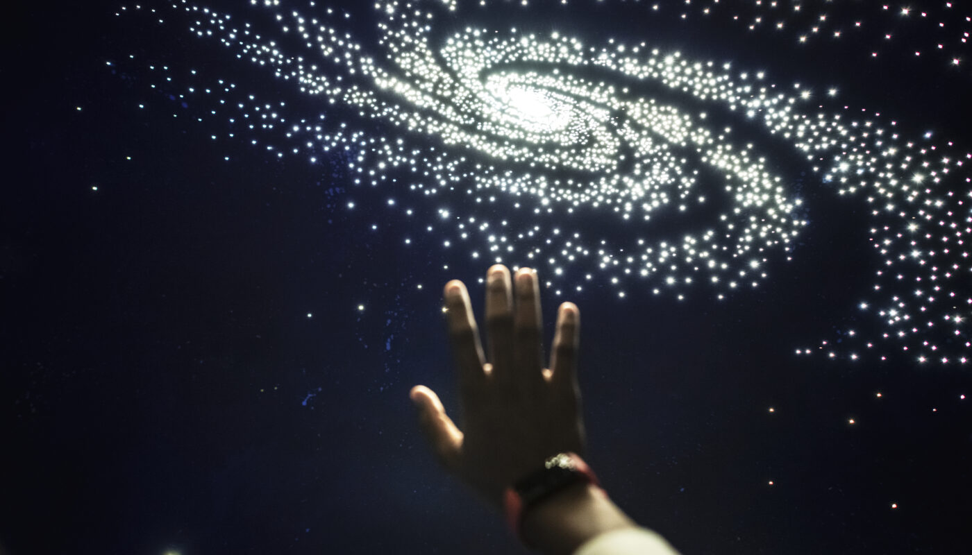 Man experiencing the universe at a planetarium